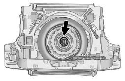 4. Turn the retainer nut counterclockwise and remove the spare tire.