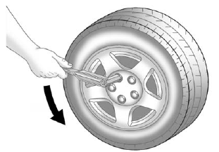 3. Loosen the wheel nuts — but do not remove them — using the wrench. For wheels with a wheel lock key, use the wheel lock key between the lock nut and wrench. The key is supplied in the front passenger door pocket.