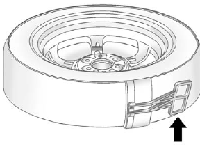 9. Remove the plastic spare tire heat shield by pulling the rubber latch. Store the plastic spare tire heat shield. See “Storing the Spare Tire” later in this section for more information.